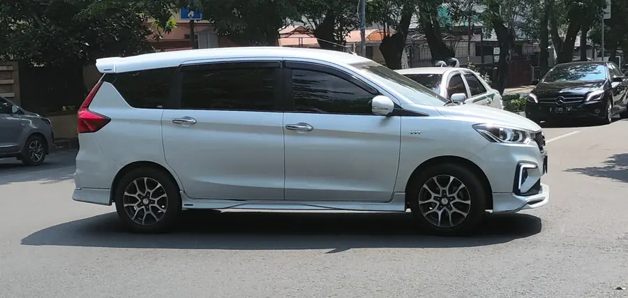 White Maruti Suzuki Ertiga side view, 6-seat compact MUV